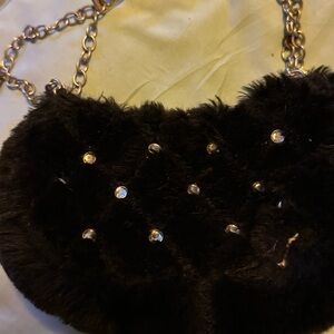black purse material, with chain handle and diamond like studs on front